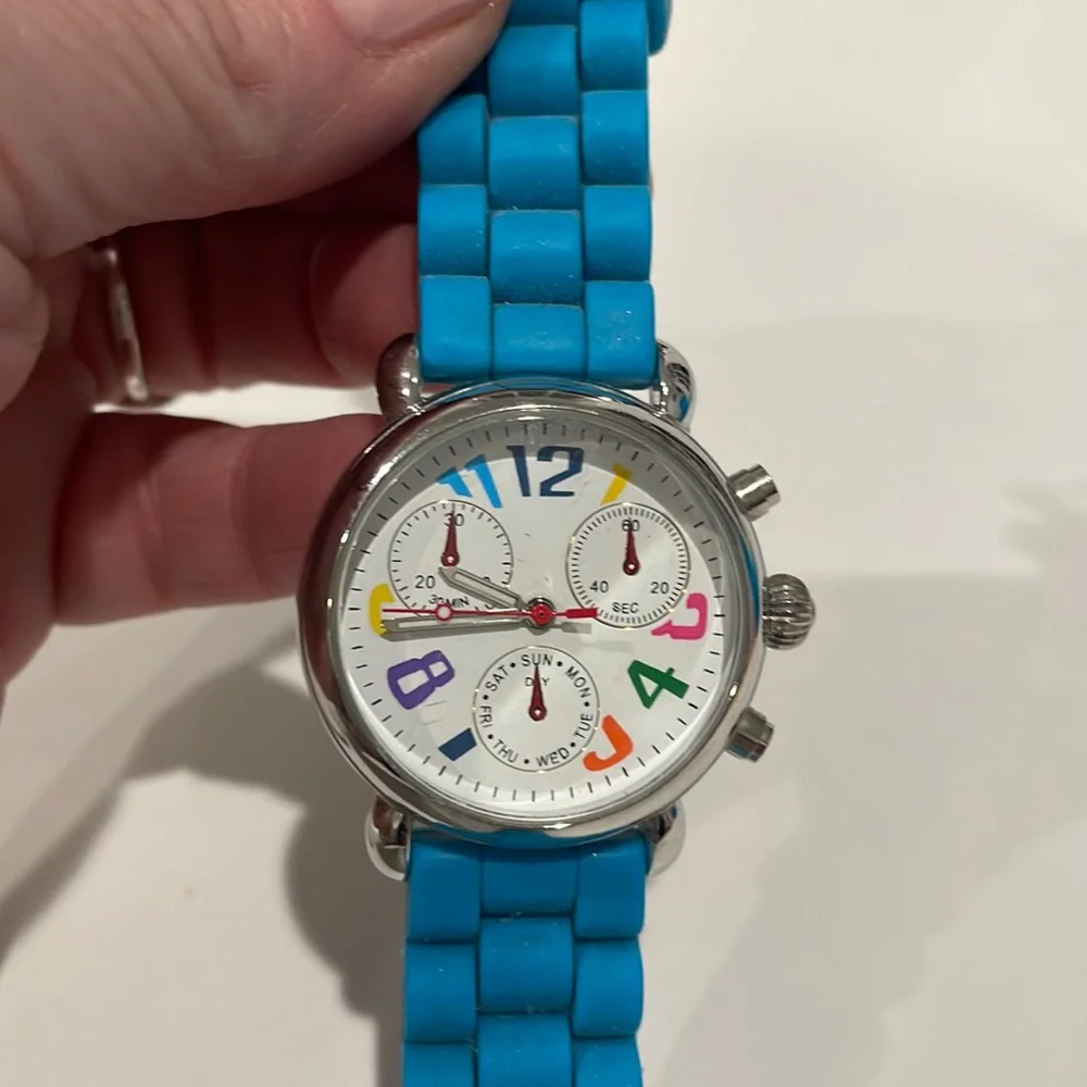 Stainless steel watch with multi color numbers and turquoise band. EUC